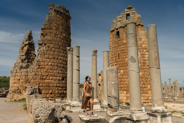 Wall Mural - tourist in The ruins of ancient Anatolian city of Perge located near the Antalya city in Turkey