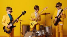 Kids Band Performing  Isolated On Yellow Background 
