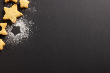 Close up of christmas cookies with copy space on black background