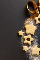 Sticker - Vertical image of close up of christmas cookies with copy space and ribbon on black background