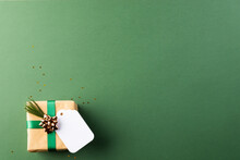 Christmas Presents With Green Ribbon And Tag With Copy Space On Green Background