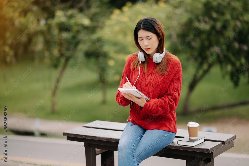 Beautiful young asian woman listening to music with headphone with ...