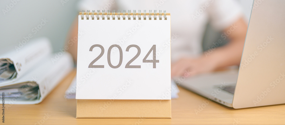 Foto de Stock 2024 Year Calendar on table with business woman using ...