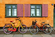 Bicycles In Front Of An Orange House Facace In Nyboder (historic Row House District Of Former Naval Barracks In Copenhagen, Denmark).