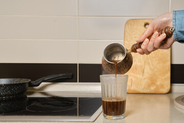 Closeup view of pouring ground coffee into a glass