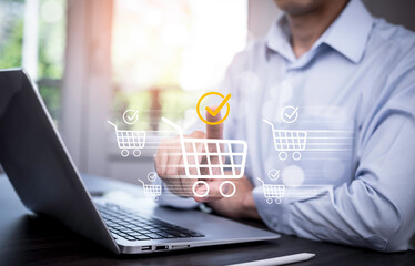 Wall Mural - Businessman hold smartphone with online shopping concept, marketplace website with virtual interface of online Shopping cart part of the network, Online shopping business with selecting shopping cart.