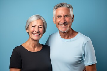 Wall Mural - Portrait of a Fictional Lovely Senior Couple wearing plain blank t-shirt on a colored background. Generative AI Illustration.