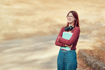 Wall Mural - Happy joyful student girl standing holding notebooks. Successful passing of exams, school and higher education.