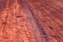 Red Dirt Road Polluted With The Iron Ore. Environmental Pollution