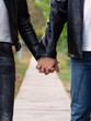 A happy, loving young couple holding hands is walking in the park. The guy and the girl are happy together.