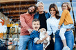 © Westend61 - Happy family with pet in front of wall