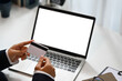 © Prathankarnpap - Close up female hands holding credit card and using laptop, doing online purchases or paying online