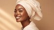 Smiling african woman model with headscarf looking away on beige background with copyspace