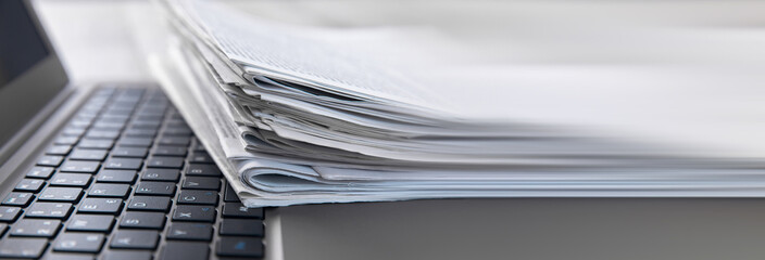 Newspapers and laptop