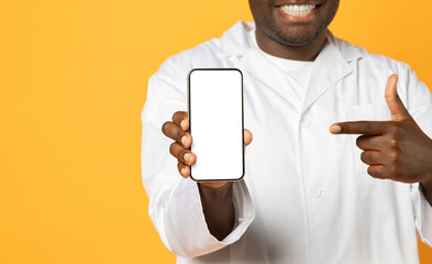 Wall Mural - Cropped Shot Of Black Doctor Man Showing Empty Smartphone Screen