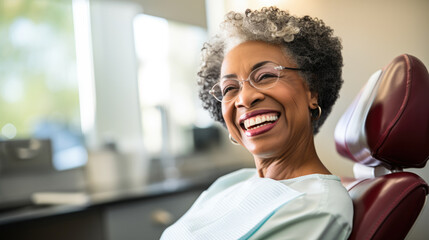 Wall Mural - Portrait of a happy dark-skinned adult woman in a dental office. African American woman undergoes a consultation with a dentist in a specialized clinic. Dental health concept.