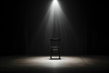 Empty Chair In A Dark Room In The Rays Of A Spotlight.
