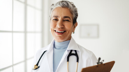 Doctor in a white lab coat looking at the camera with a welcoming smile