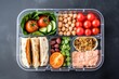 separate compartments in a lunch box with mixed foods