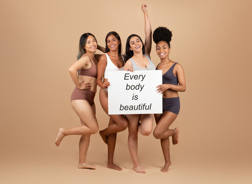 Women of diverse races with Every body is beautiful placard