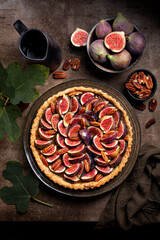 Canvas Print - California Fig and Bourbon Pecan Pie or tart, homemade pie crust with figs, brown sugar, butter, eggs and pecans filling, decorated with fresh figs and toasted pecan. Brown table, vertical image.