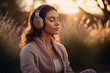  Young asian woman with eyes closed listening music through headphones while meditating