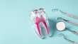 Dental care and treatment concept, tooth with dentist instruments on blue background