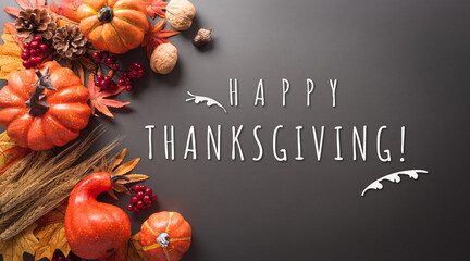 Wall Mural - thanksgiving and autumn decoration concept made from autumn leaves, pumpkin and the text on dark bac