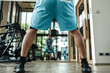 A man doing squat exercises with dumbbell at gym. Fitness, workout and training concept.