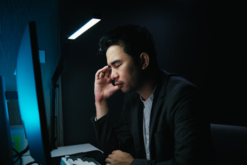 Poster - Stressed, tired business man suffering from headache, working late night in the office. Worried male entrepreneur thinking about problems and project deadline feeling burnout, stress and exhausted