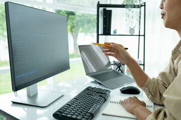 Female IT programmer innovates at office desk.