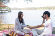© MIND AND I - Couple having a picnic in a beautiful and natural park