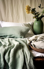 Wall Mural - Comfortable bed with olive green linen in modern room interior