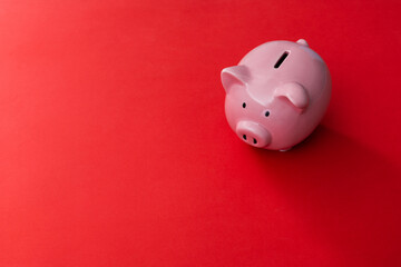 Poster - Piggy bank on red background