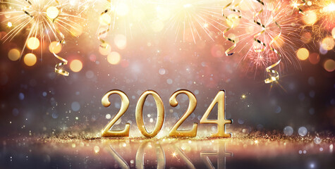 Wall Mural - 2024 happy new year - golden number on glitter and fireworks in abstract defocused lights