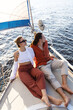 © blackday - Young attractive couple relaxing on the sailboat during sailing in the sea