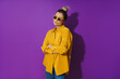 © blackday - Young  girl wearing yellow shirt and sunglasses showing disdain expression against purple background