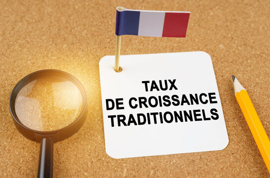 On the table is the flag of France and a sheet of paper with the inscription - traditional growth rates