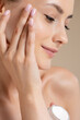 © WellStock - Young adorable woman using moisturising face cream
