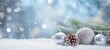 Festive christmas ornaments advent celebration holiday banner greeting card - Silver christmas baubles balls, pine cones and branch on snow table, with blue sky and snowflakes in background