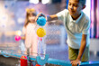 © rh2010 - Little boy plays with a ball on a steam of water, learning physical phenomena in an interesting way, having fun in a science museum with interactive models