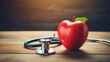 Stethoscope and red apple with heart shape on wood table