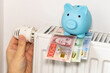 costs of heating apartments in winter in Sweden, Energy and economic concept, Hand unscrewing the radiator, piggy bank and Swedish krona