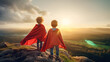Kids wearing superhero capes posing confidently on top of a hill during sunset. 