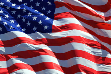 American flag waving in the wind against blue sky