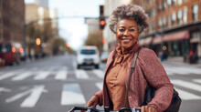 Portrait of active senior woman walking on street with bicycle.