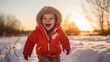 Happy toddler boy in warm coat and knitted hat tossing up snow and having a fun in the winter outside, outdoor portrait