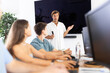 © JackF - Adult man speaker in study room stands in front of group of web design students and talks about principles of coloristics