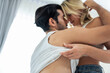 © Kawee - Caucasian young man and woman starting foreplay and making love on bed.
