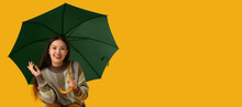 Beautiful Young Asian Woman With Umbrella On Yellow Background With Space For Text